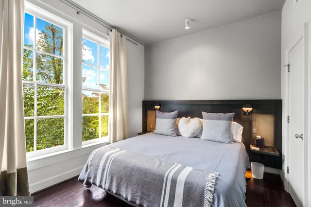 a bedroom with a large bed and a large window