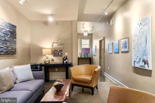 a living room with furniture and a lamp