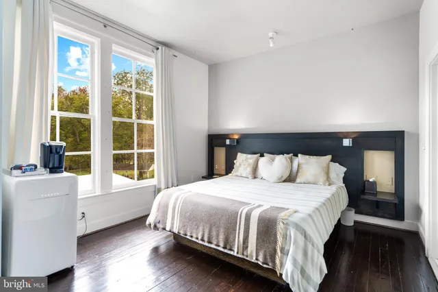 a bedroom with a large bed and a window