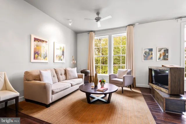 a living room with furniture flat screen tv and a fireplace