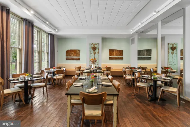 a living room with lots of furniture and wooden floor