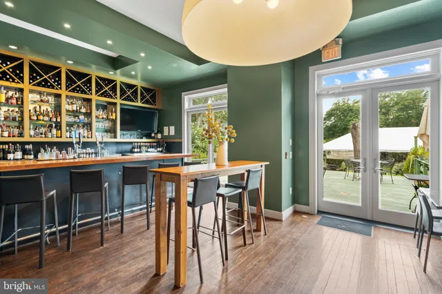 a kitchen with a table chairs stove and wooden floor