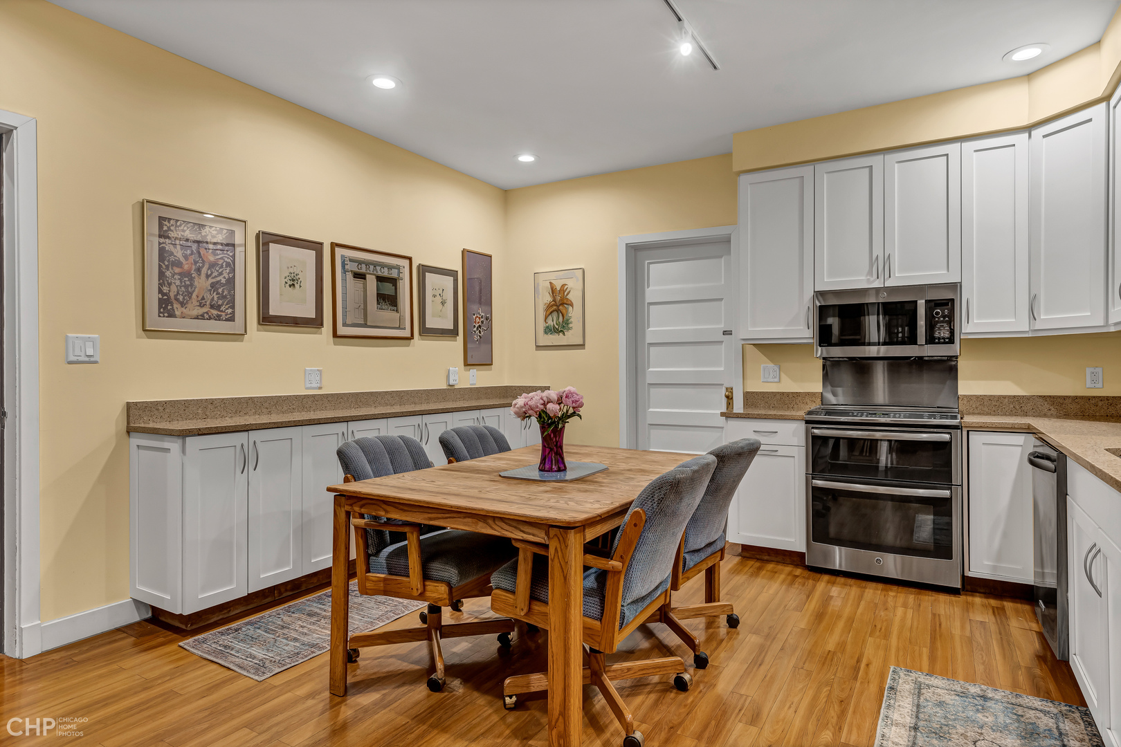 684 West Irving Park Road, Unit E5 Chicago, IL 60613 - Photo 21 of 45 a view of a dining room with furniture and wooden floor
