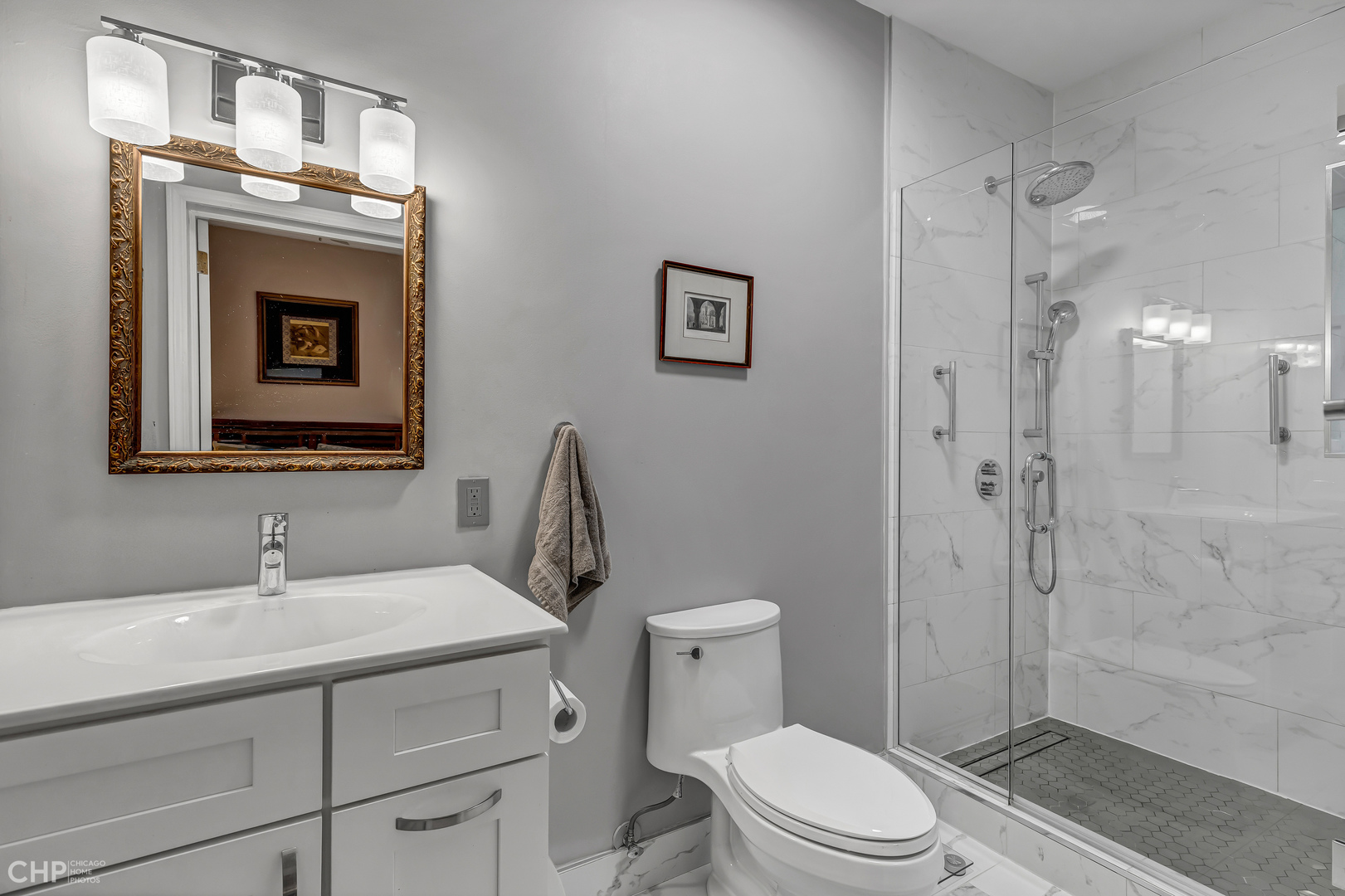 684 West Irving Park Road, Unit E5 Chicago, IL 60613 - Photo 28 of 45 a bathroom with a toilet a sink and shower