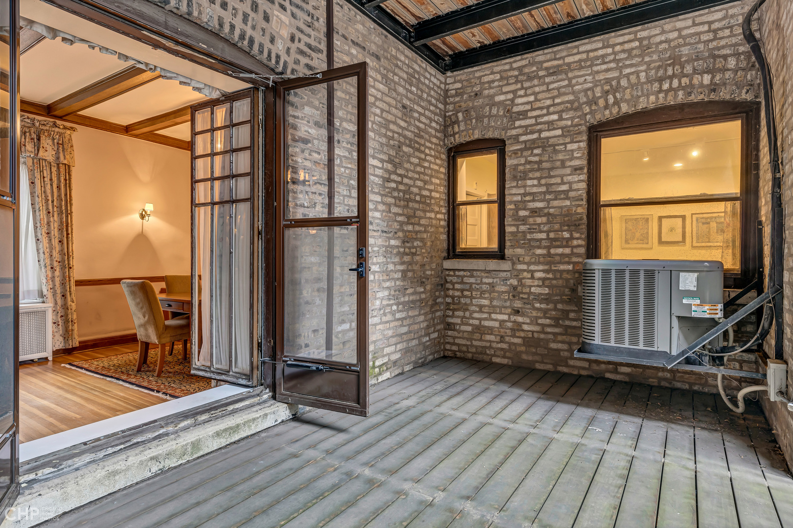 684 West Irving Park Road, Unit E5 Chicago, IL 60613 - Photo 34 of 45 a view of a balcony with wooden floor and fence