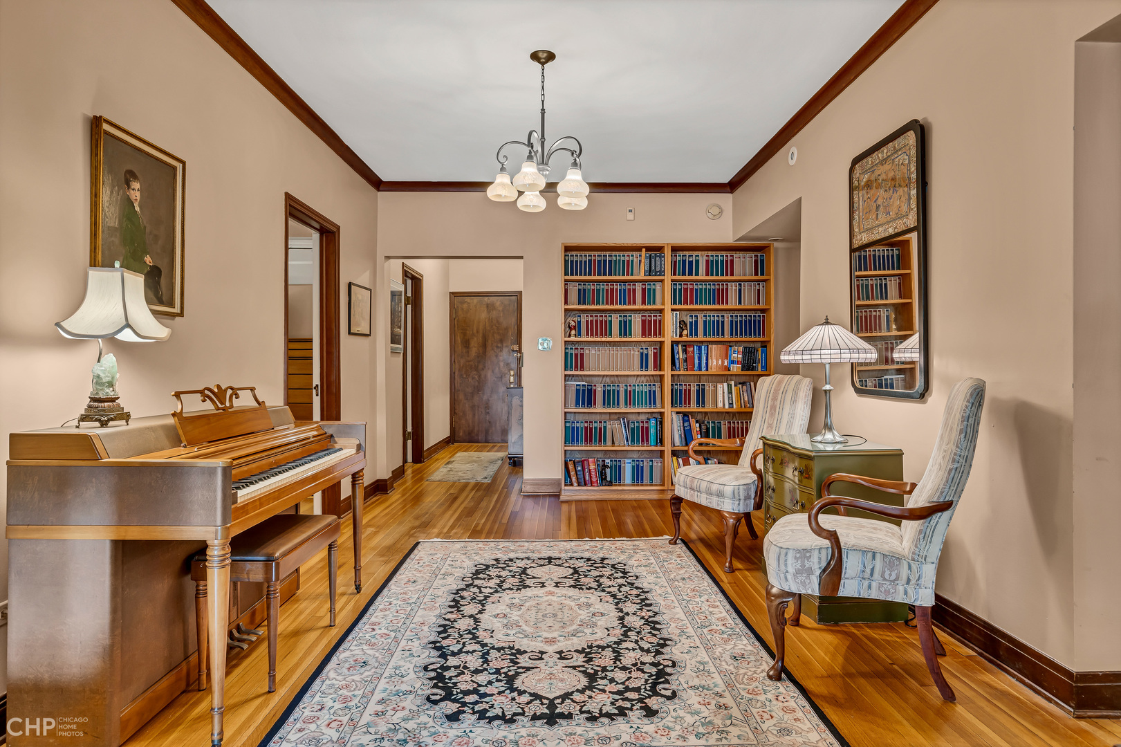 684 West Irving Park Road, Unit E5 Chicago, IL 60613 - Photo 5 of 45 a living room with furniture and a chandelier