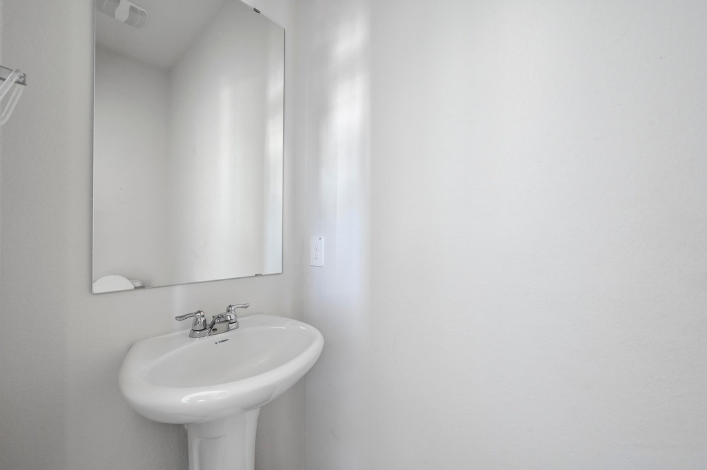 229 Frogmore Loop Kyle, TX 78640 - Photo 13 of 30 a bathroom with a sink and a mirror
