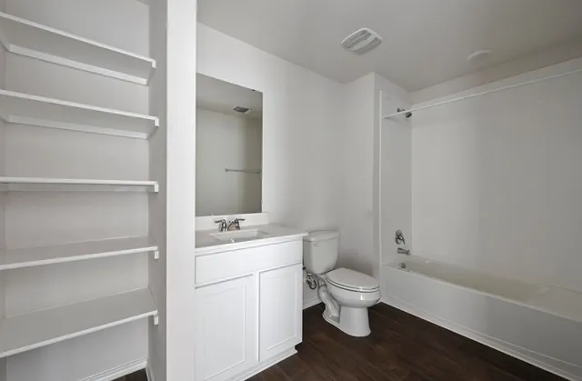 a bathroom with a sink a toilet a shower and a mirror