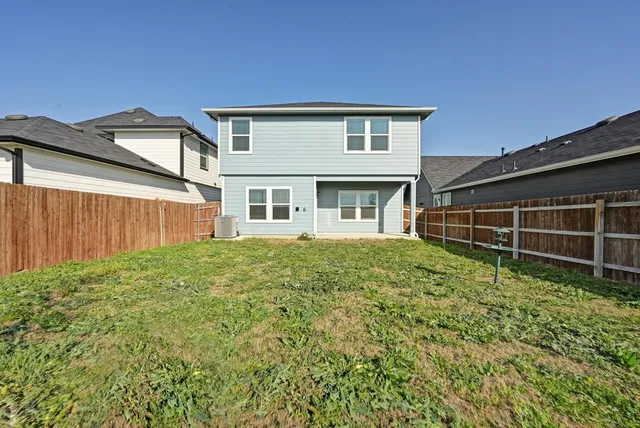 a view of a house with a backyard