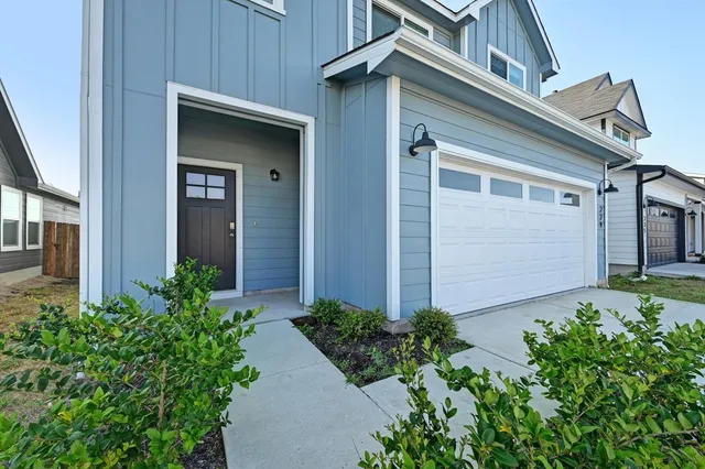 front view of a house with potted plants