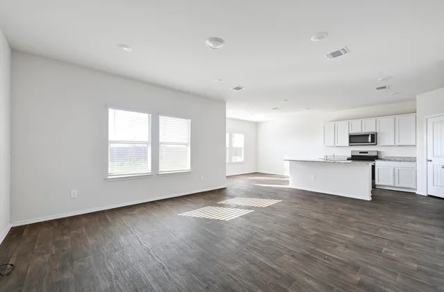 a view of kitchen with wooden floor and electronic appliances