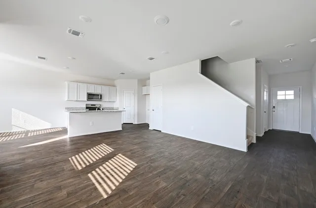 a view of kitchen with wooden floor and electronic appliances