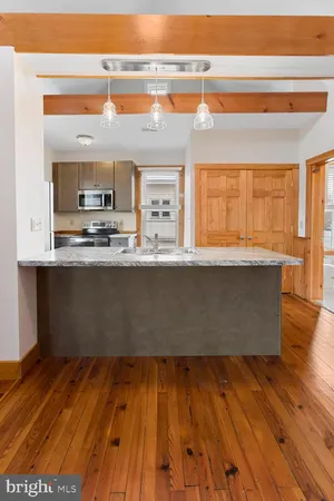 a view of kitchen with wooden floor