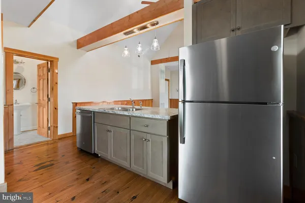 a kitchen with stainless steel appliances granite countertop a refrigerator and a stove