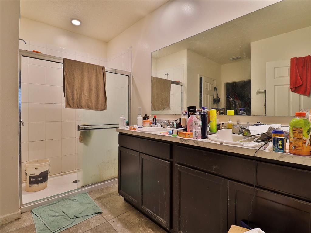 1997 Southwest Cycle Street Port St. Lucie, FL 34953 - Photo 12 of 30 a bathroom with a double vanity sink a mirror and shower