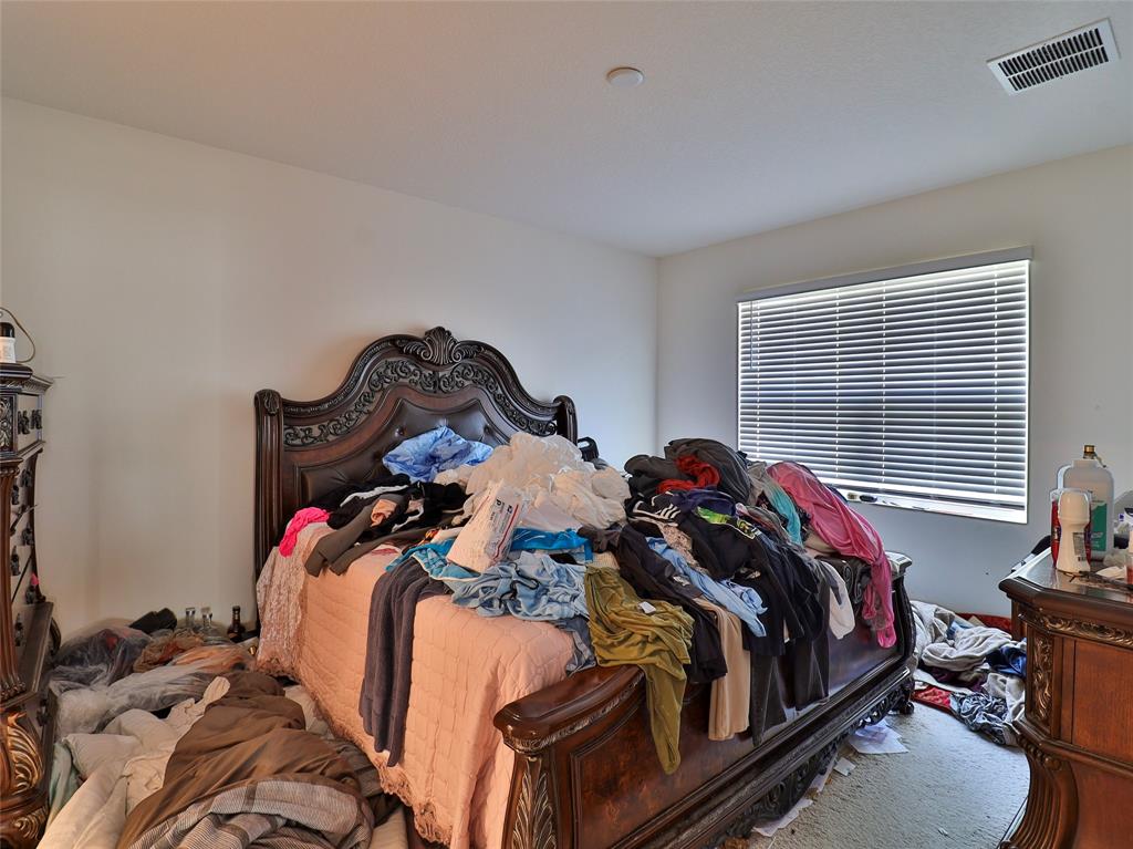 1997 Southwest Cycle Street Port St. Lucie, FL 34953 - Photo 13 of 30 a bed sitting in a bedroom next to a window