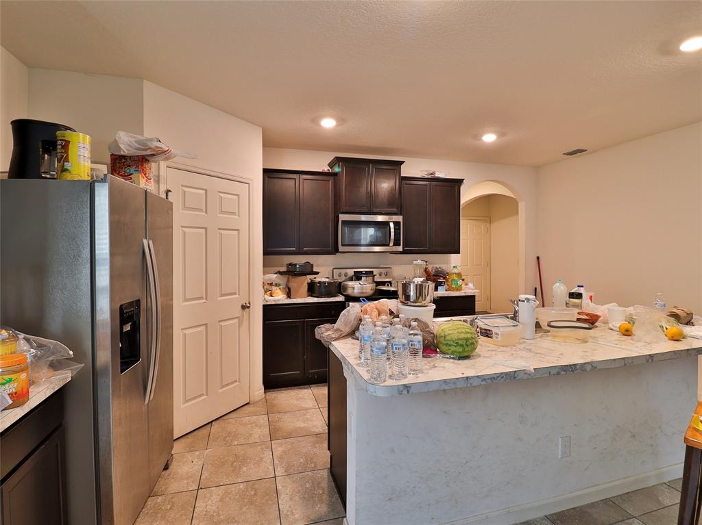 1997 Southwest Cycle Street Port St. Lucie, FL 34953 - Photo 19 of 30 a kitchen with refrigerator and cabinets