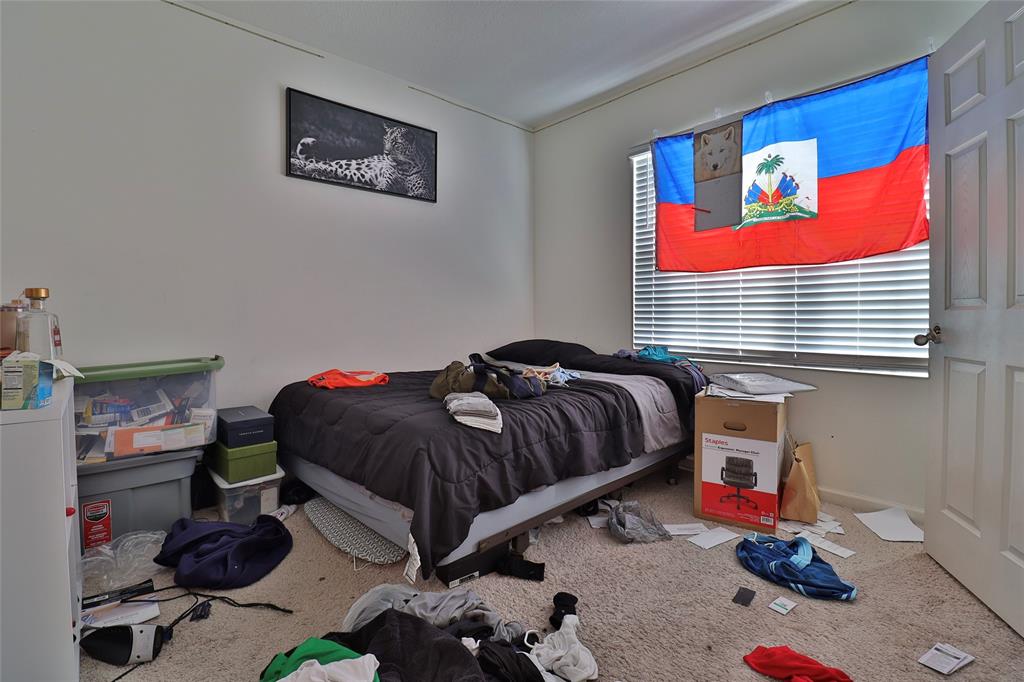 1997 Southwest Cycle Street Port St. Lucie, FL 34953 - Photo 29 of 30 a bedroom with a bed and dresser