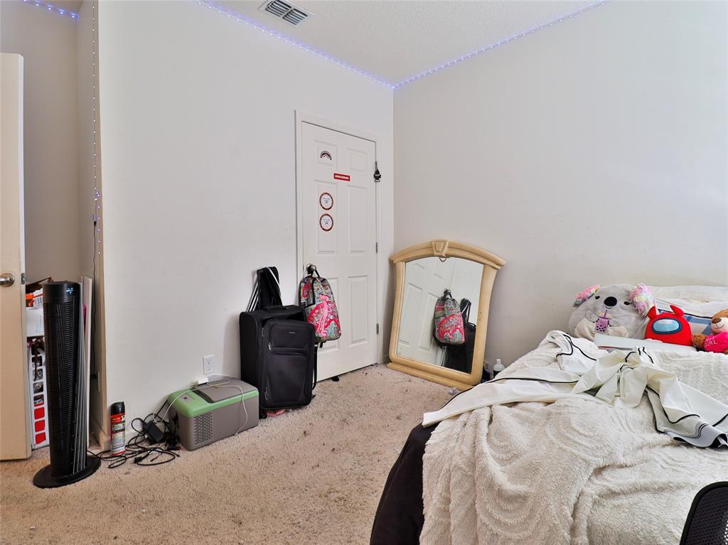 1997 Southwest Cycle Street Port St. Lucie, FL 34953 - Photo 4 of 30 a bedroom with a bed and a chandelier