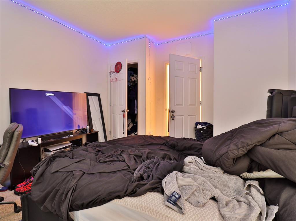 1997 Southwest Cycle Street Port St. Lucie, FL 34953 - Photo 6 of 30 a bedroom with a bed and a flat screen tv