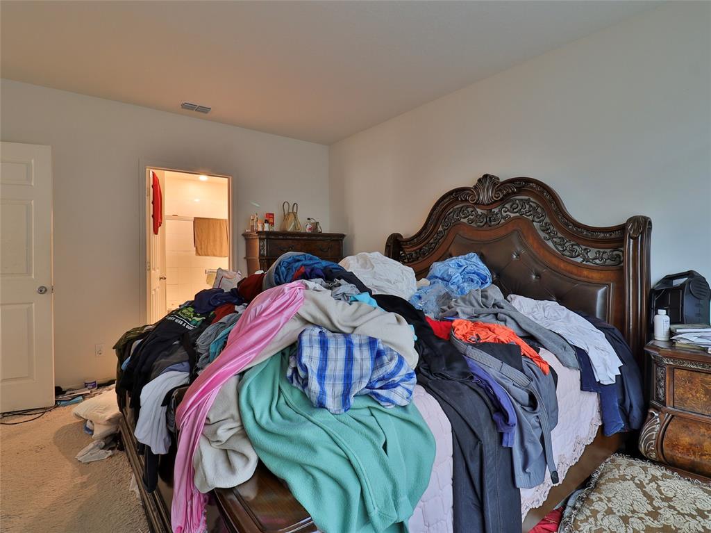 1997 Southwest Cycle Street Port St. Lucie, FL 34953 - Photo 8 of 30 a bed sitting in a bedroom next to a window