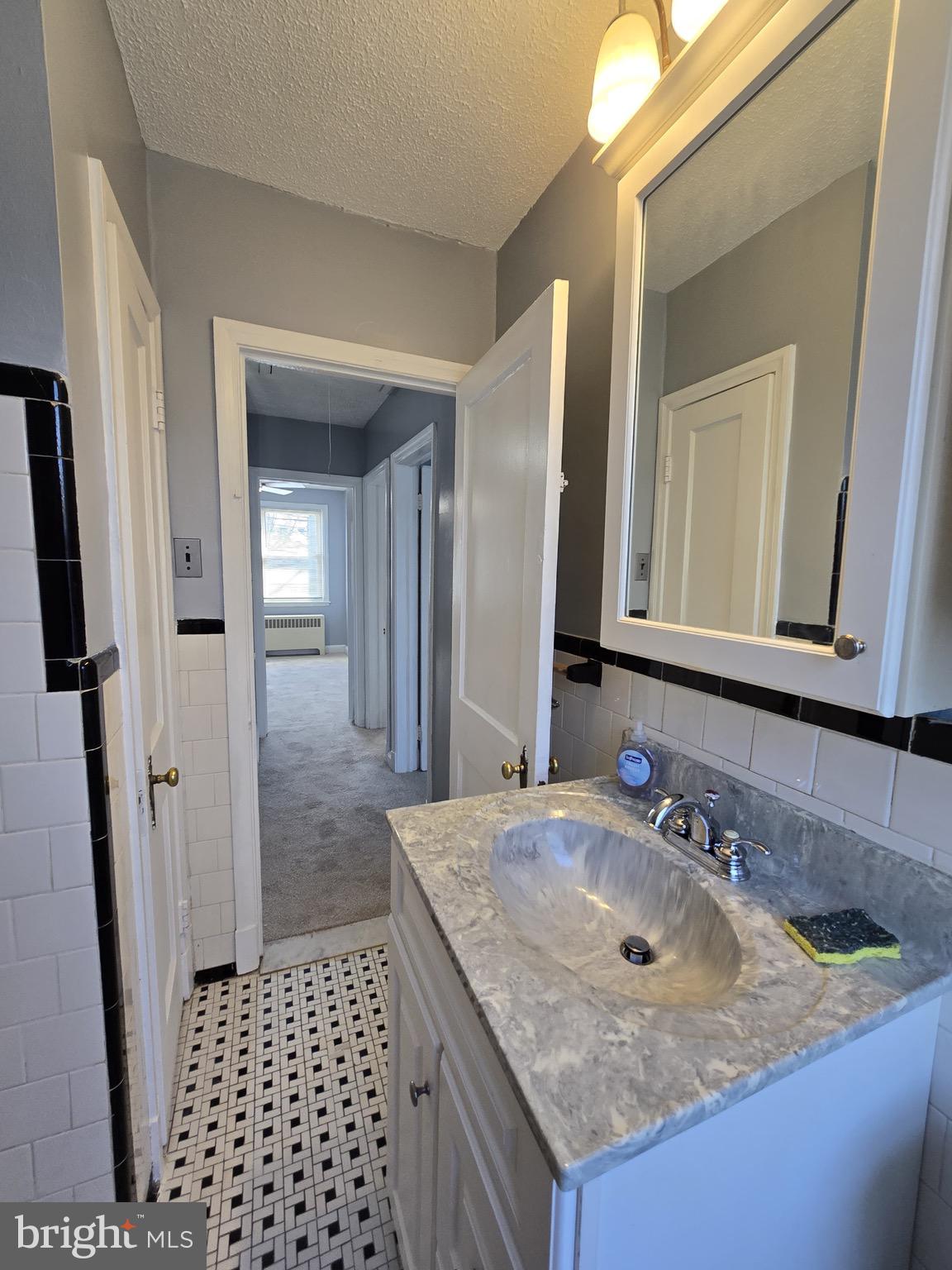 6105 Frederick Road Catonsville, MD 21228 - Photo 15 of 38 a bathroom with a granite countertop sink and a mirror