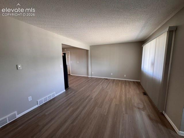 1922 Monterey Road Colorado Springs, CO 80910 - Photo 3 of 21 wooden floor in an empty room with a window