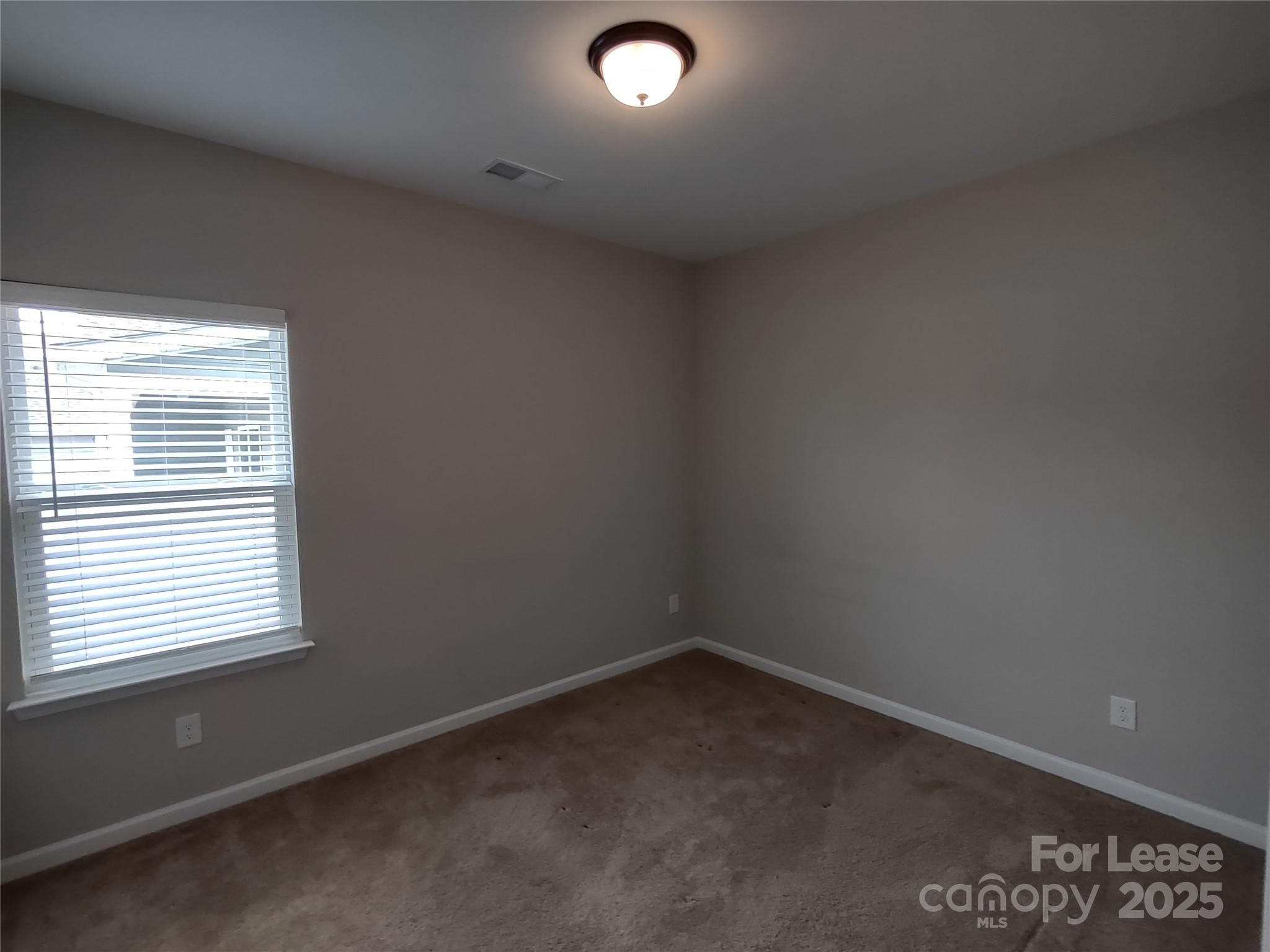 143 Kingston Drive Locust, NC 28097 - Photo 14 of 16 an empty room with a window