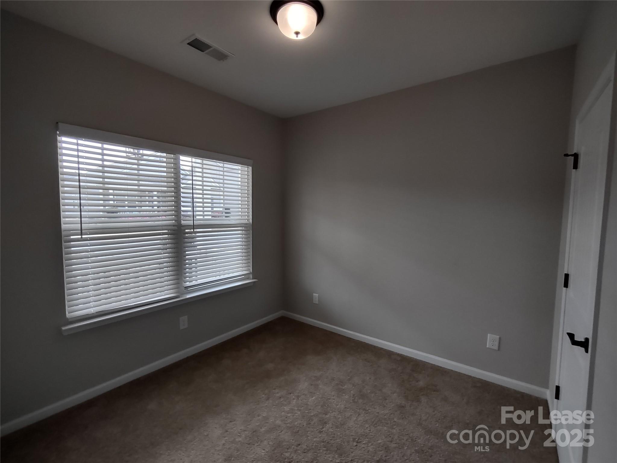 143 Kingston Drive Locust, NC 28097 - Photo 7 of 16 an empty room with a window