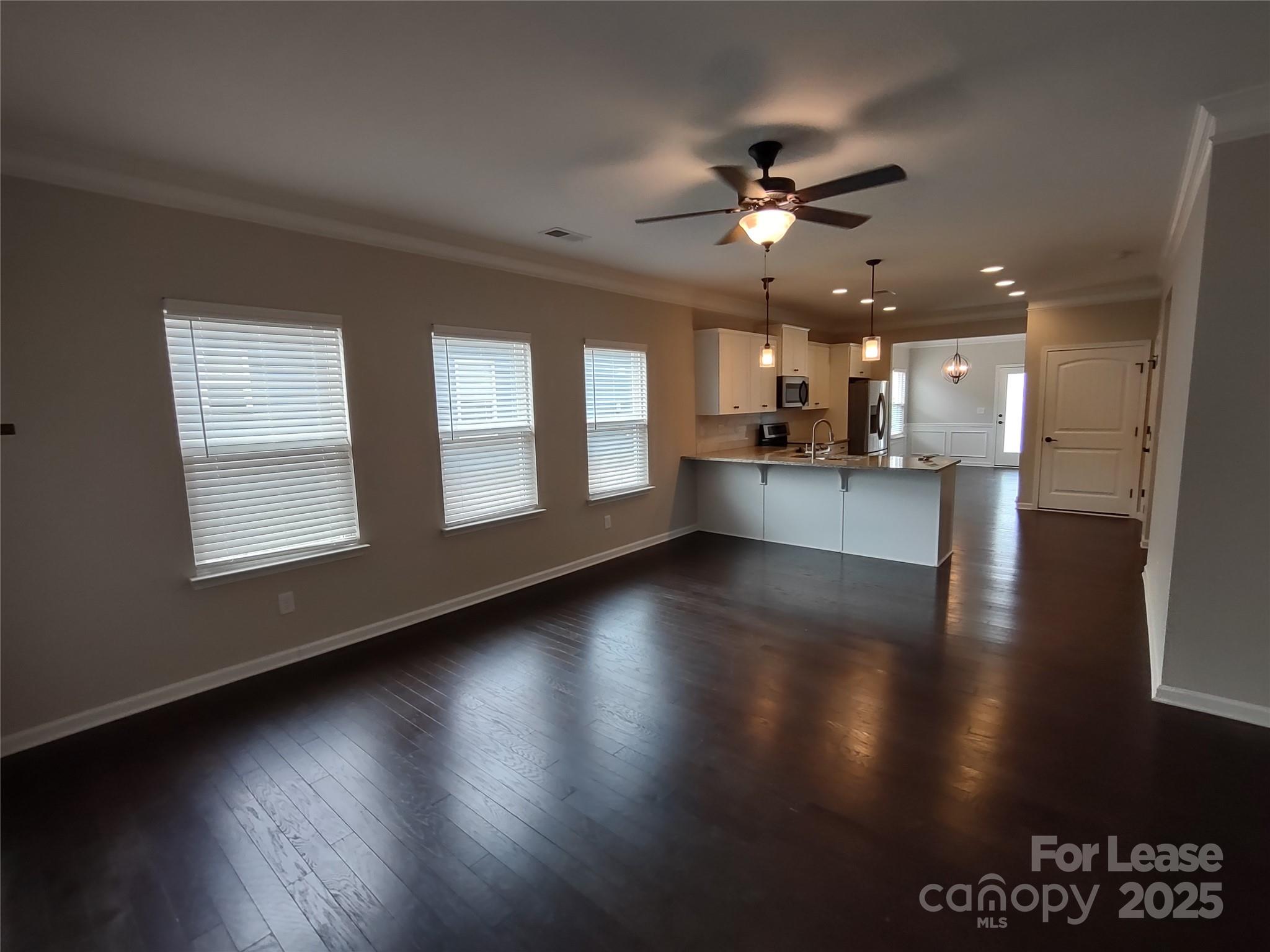 143 Kingston Drive Locust, NC 28097 - Photo 8 of 16 a view of an empty room with wooden floor and a window