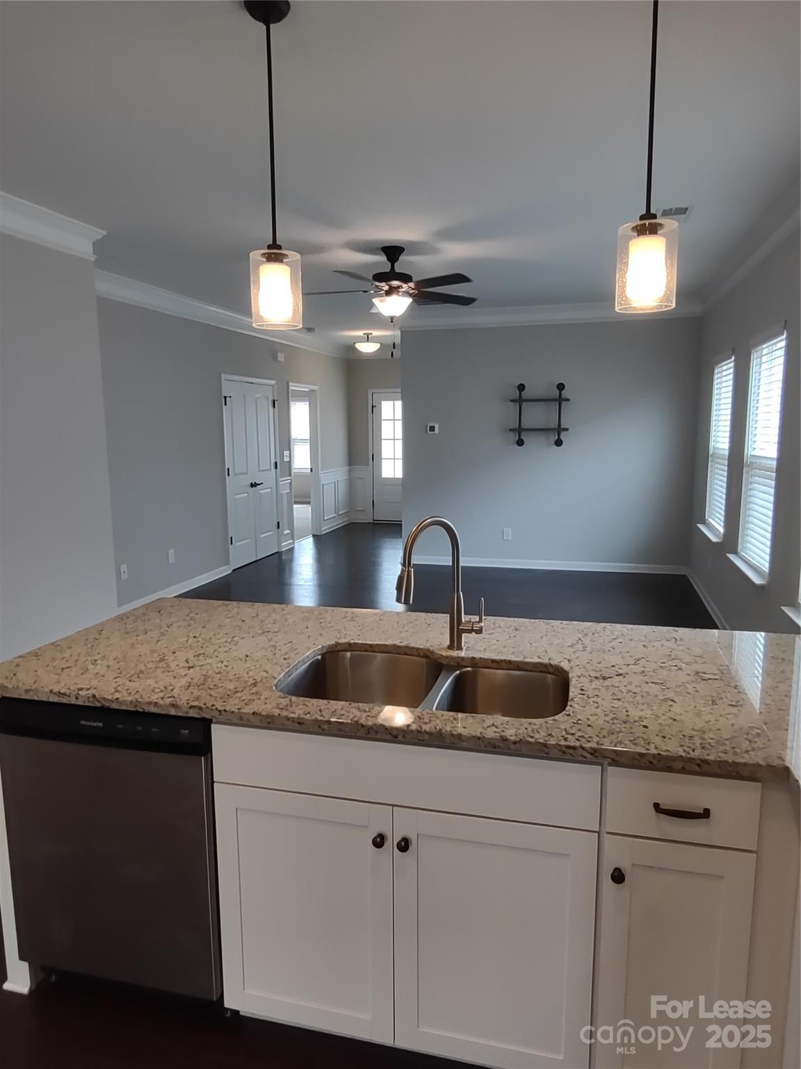143 Kingston Drive Locust, NC 28097 - Photo 9 of 16 a kitchen with granite countertop a sink and chandelier