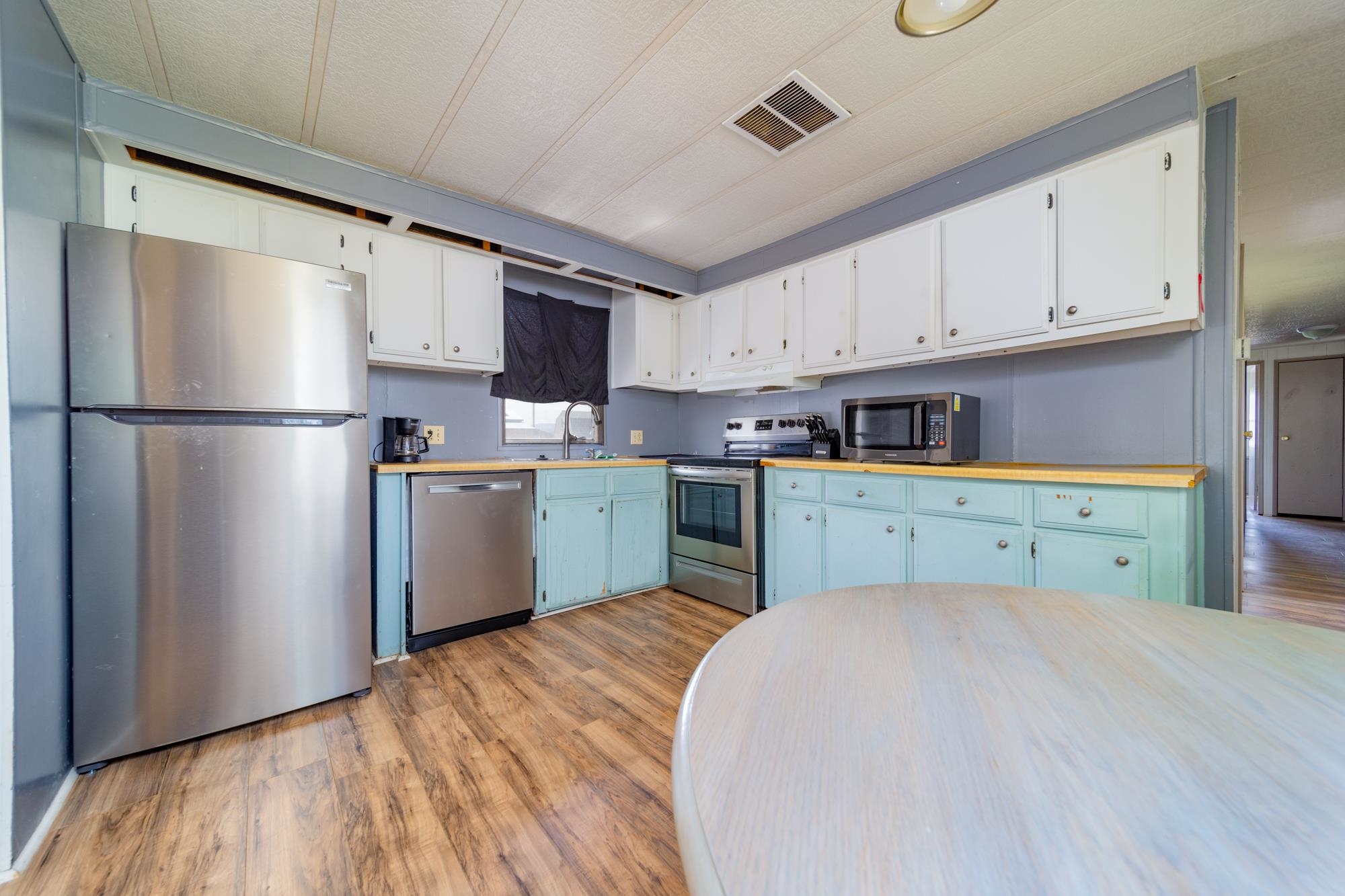 1047 Old Highway Mack, CO 81525 - Photo 5 of 16 a kitchen with a refrigerator a sink and cabinets