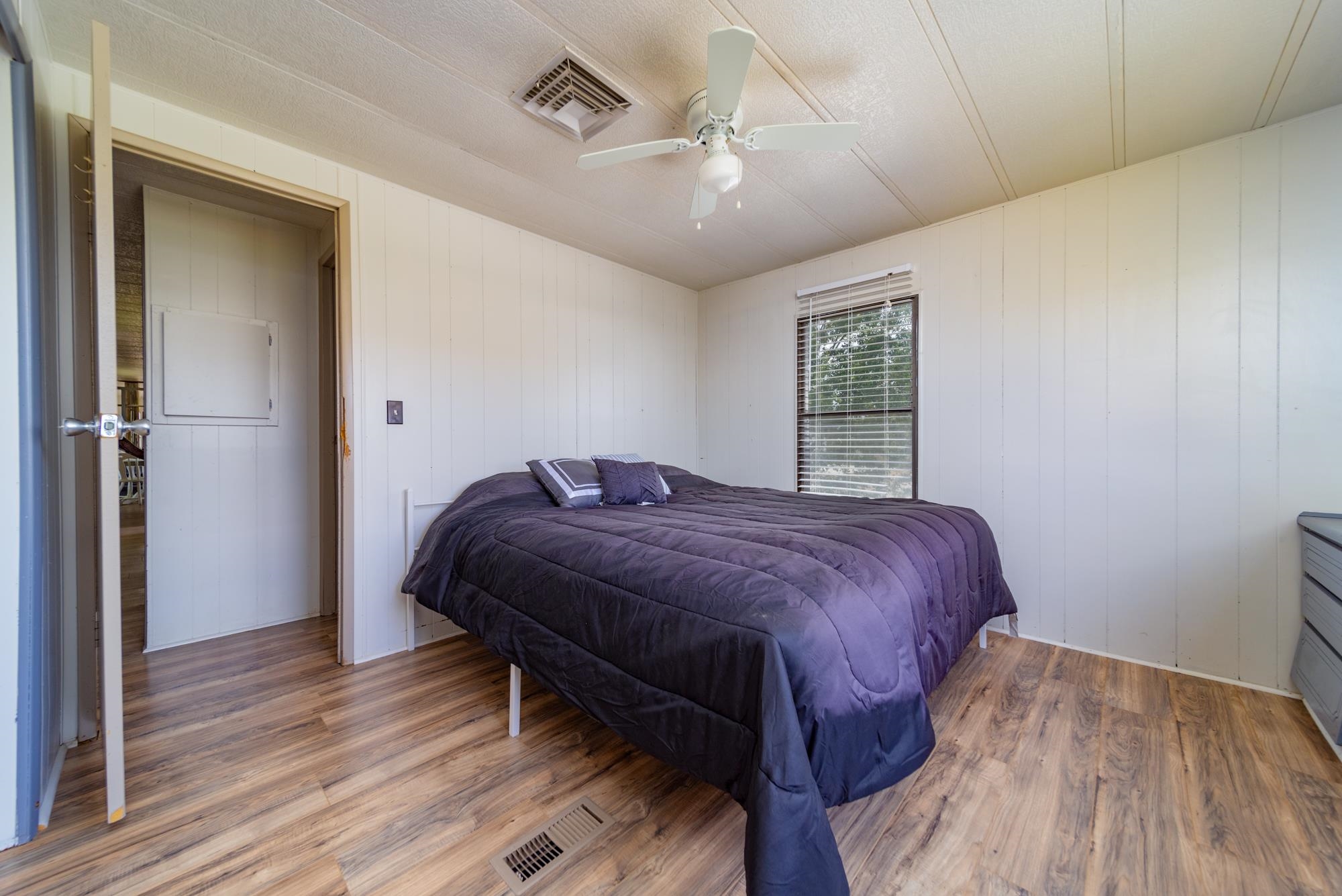1047 Old Highway Mack, CO 81525 - Photo 9 of 16 a bedroom with a bed and a wooden floor