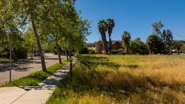 a view of yard with swimming pool and trees