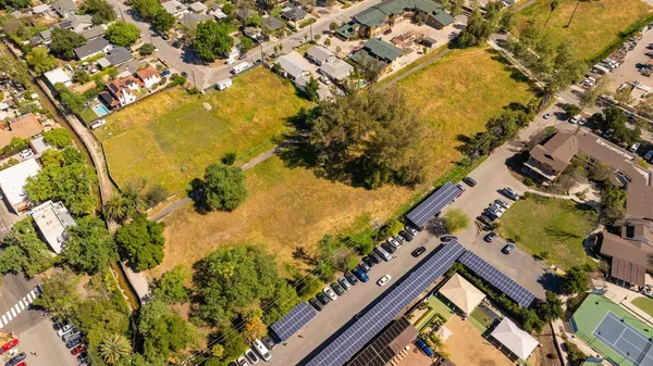 an aerial view of residential houses with outdoor space