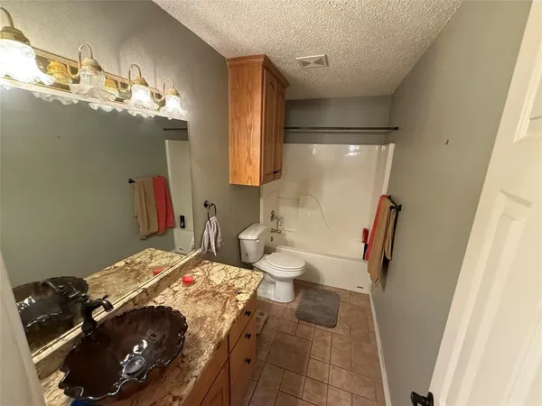 a bedroom with a bed and a mirror