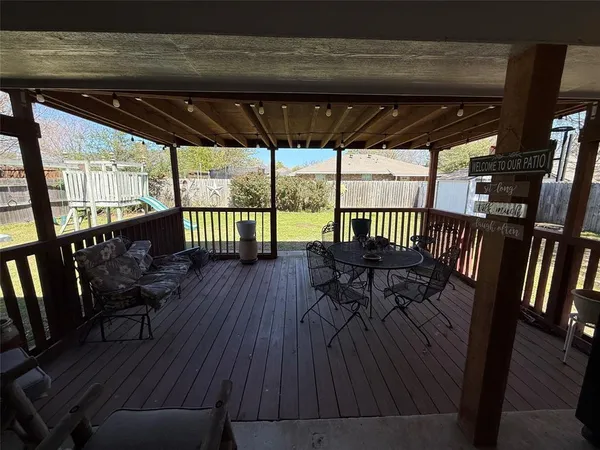 a view of porch with a table and a chairs