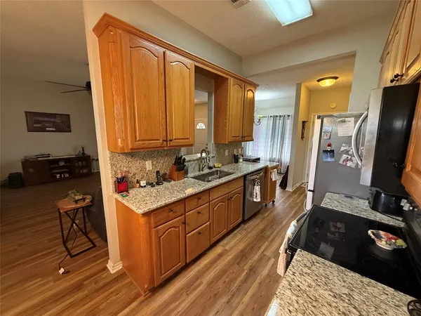 a kitchen with a refrigerator stove and a sink