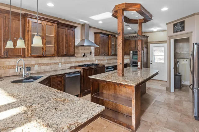 a kitchen with stainless steel appliances granite countertop wooden cabinets a sink dishwasher and stove