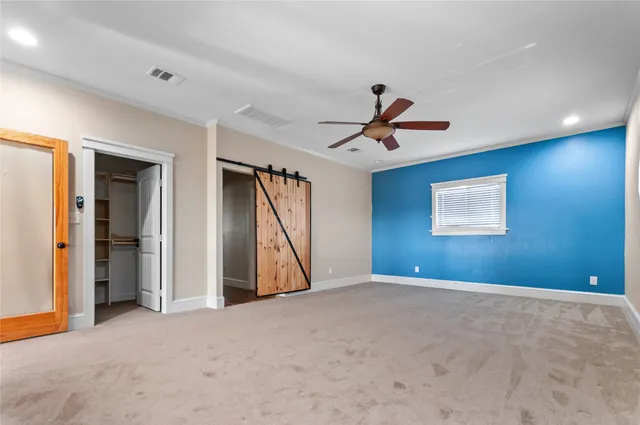 a view of an empty room with a ceiling fan