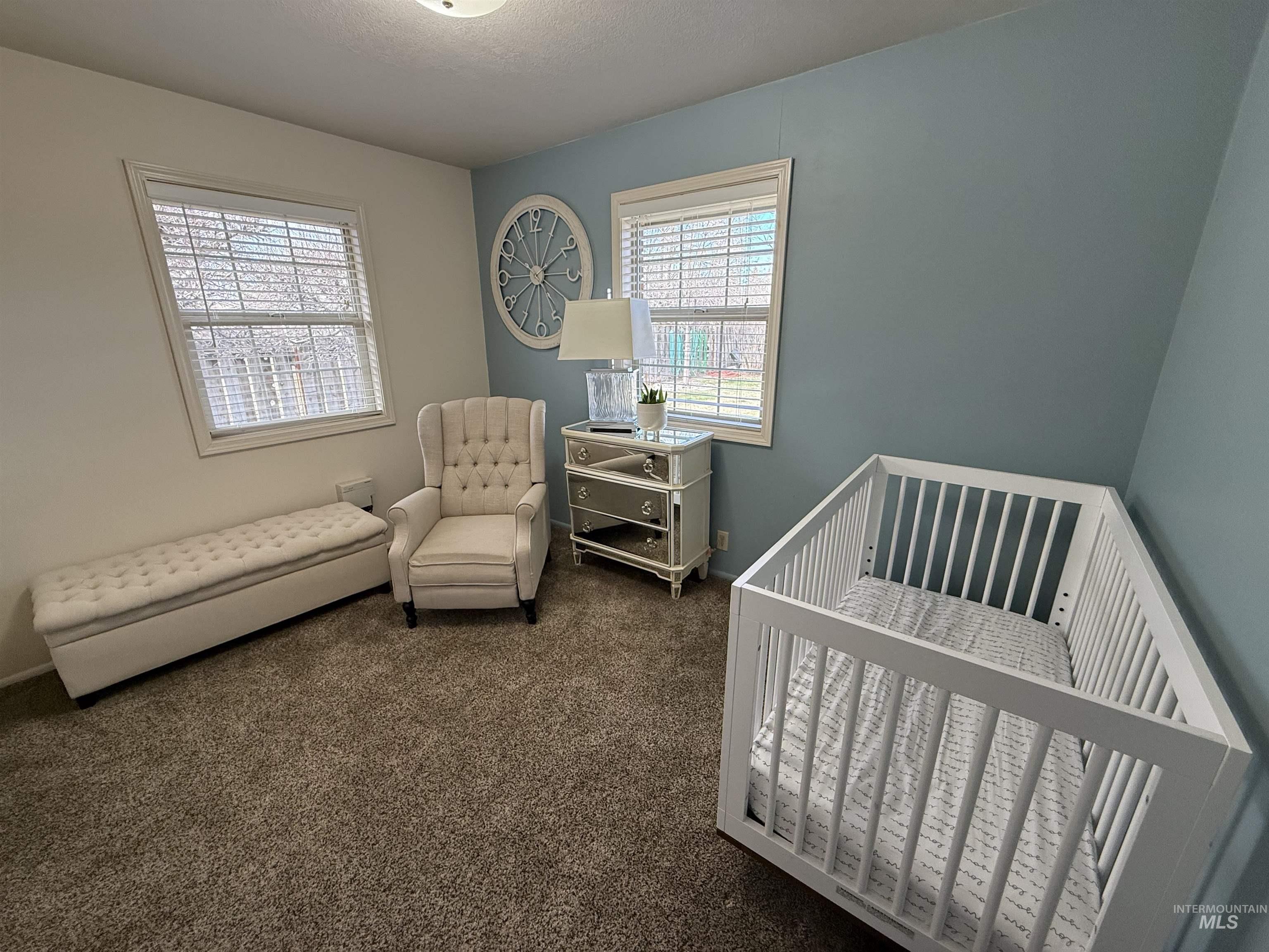 624 20th Street Rupert, ID 83350 - Photo 16 of 31 Bedroom featuring dark colored carpet and a nursery area