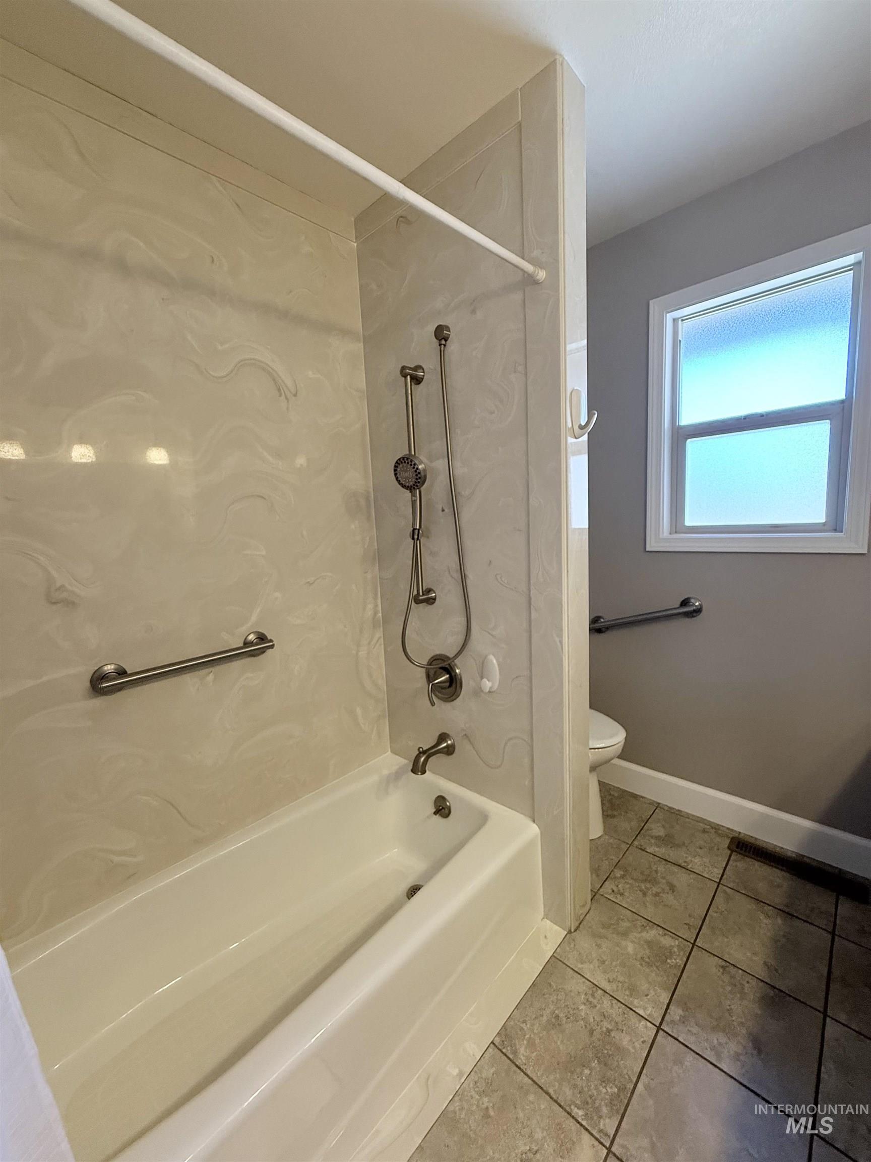 624 20th Street Rupert, ID 83350 - Photo 18 of 31 Full bathroom with light tile patterned floors and shower / bath combination with curtain