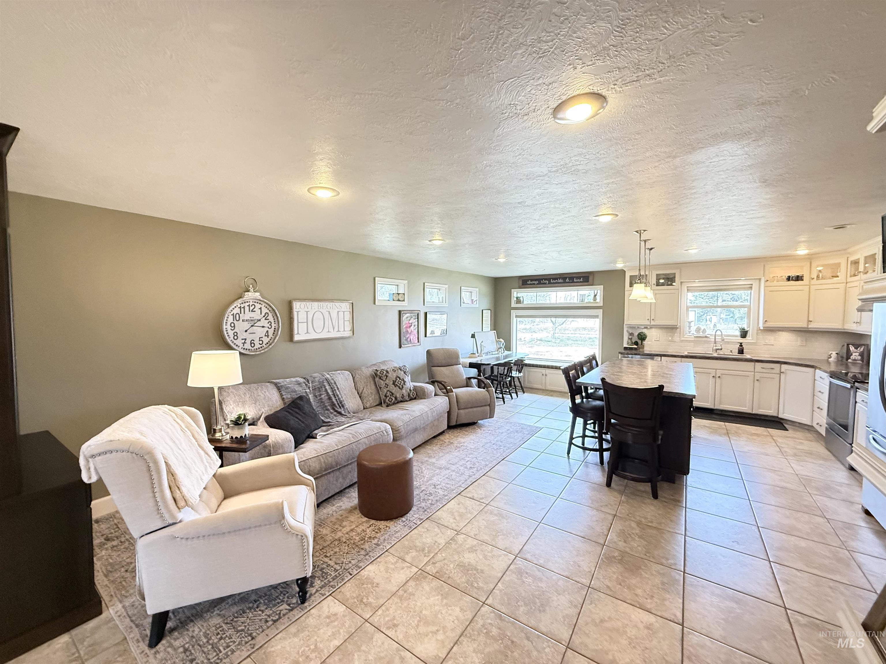 624 20th Street Rupert, ID 83350 - Photo 5 of 31 Living area featuring a textured ceiling, light tile patterned floors, and recessed lighting