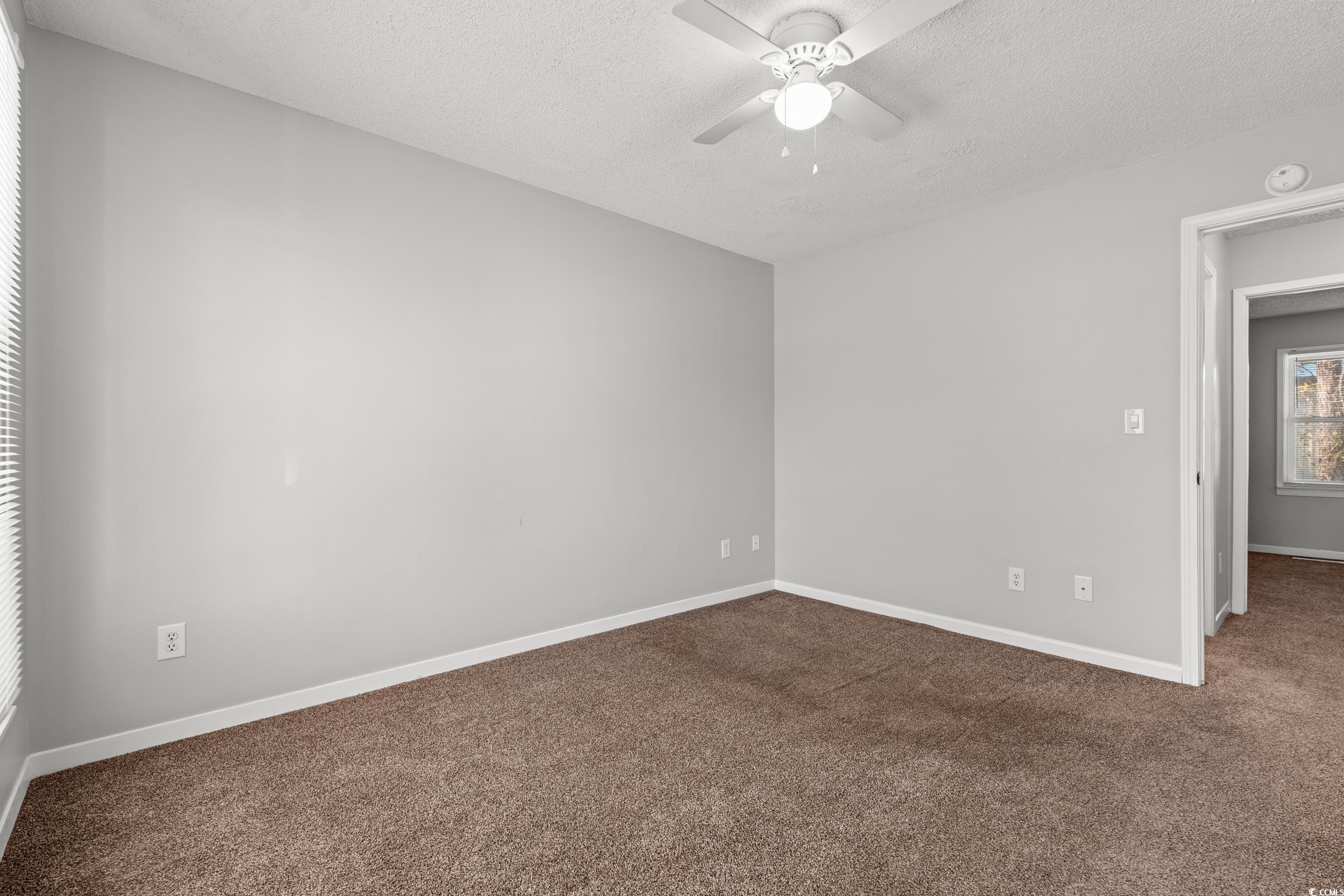 3458 Macklen Road Myrtle Beach, SC 29588 - Photo 20 of 30 Unfurnished room with a ceiling fan, carpet flooring, a textured ceiling, and baseboards