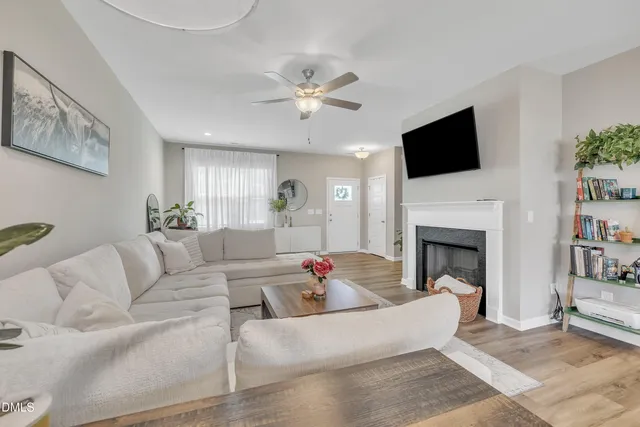 a living room with fireplace furniture and a flat screen tv
