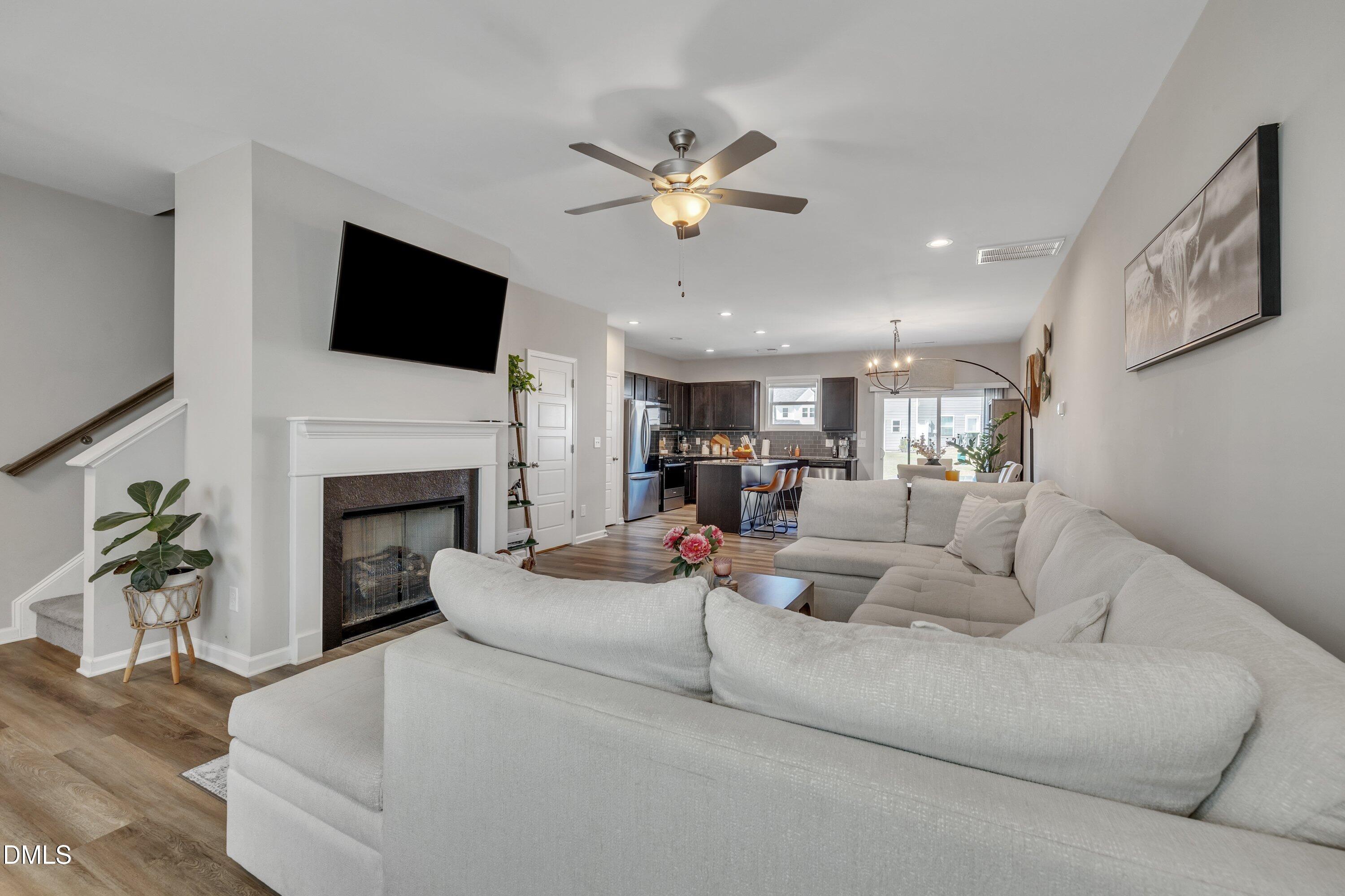 743 Hadstock Path Zebulon, NC 27597 - Photo 17 of 39 a living room with fireplace furniture and a flat screen tv