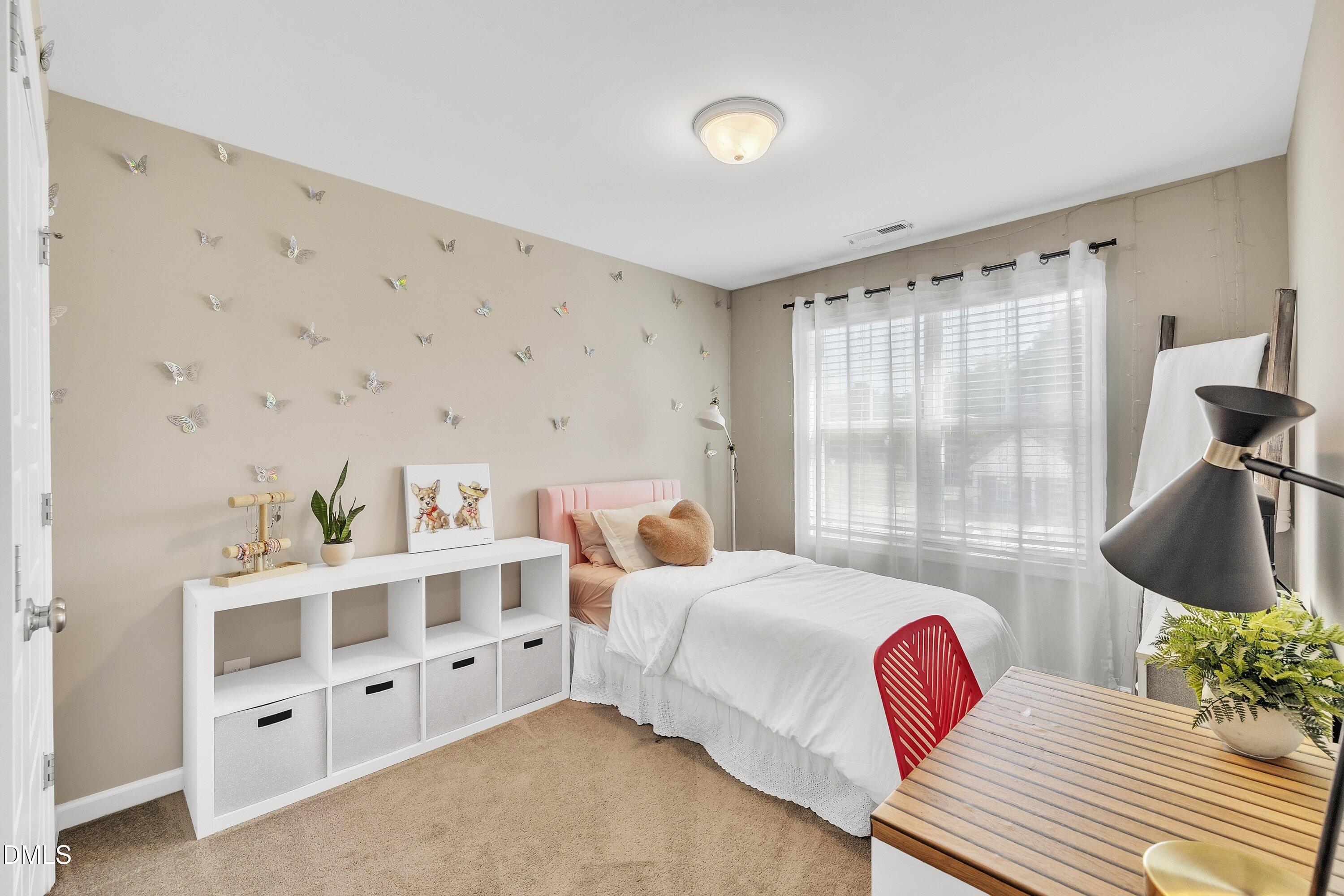 743 Hadstock Path Zebulon, NC 27597 - Photo 29 of 39 a bedroom with furniture and a flat screen tv