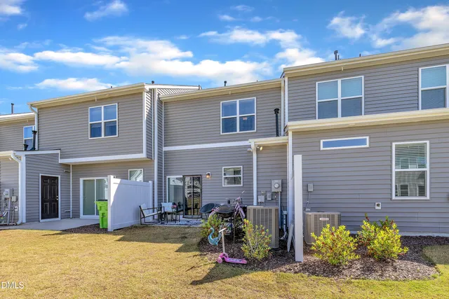 a aerial view of a swimming pool with lawn chairs under an umbrella