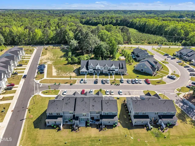 an aerial view of residential houses with outdoor space