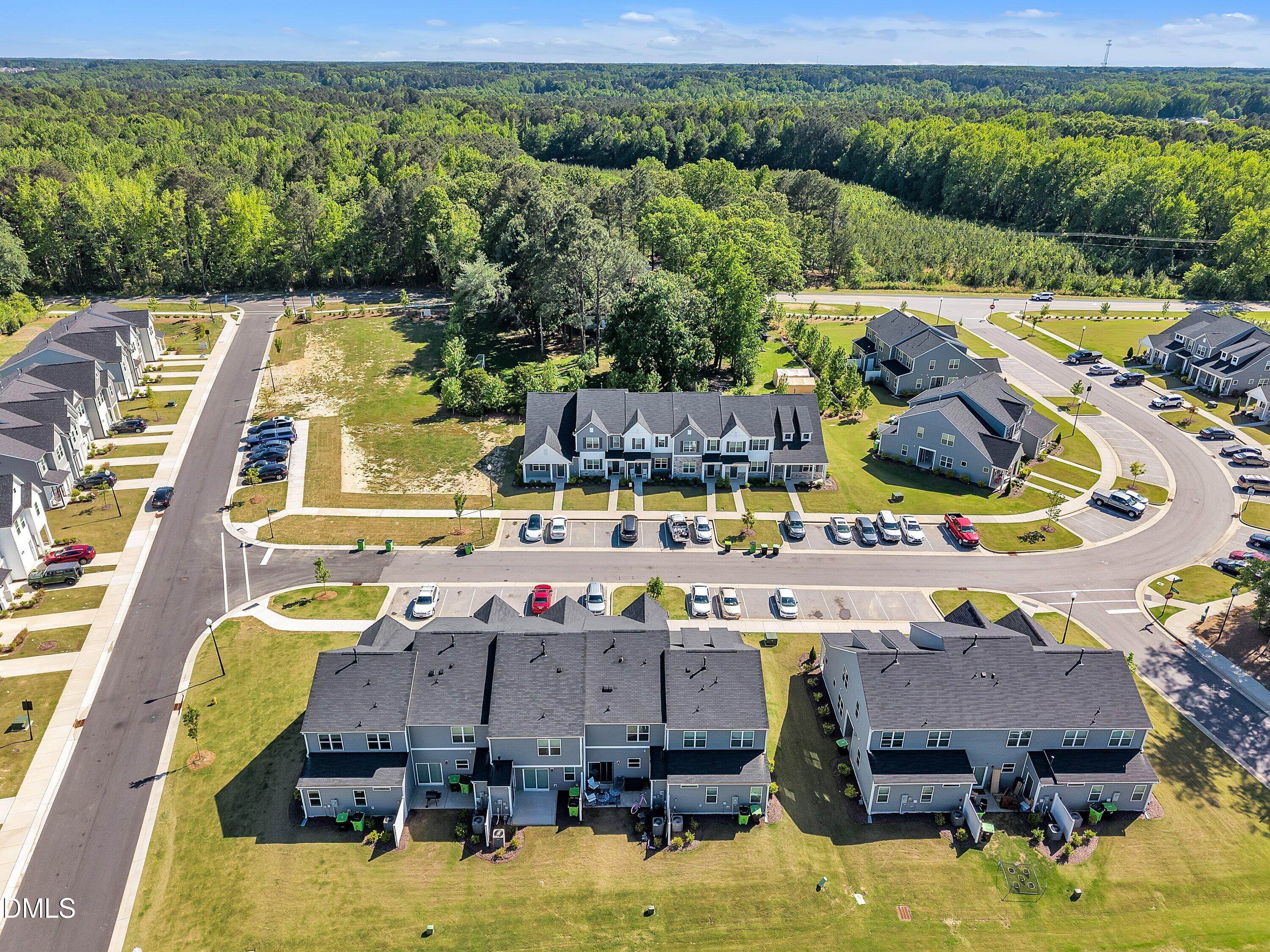 743 Hadstock Path Zebulon, NC 27597 - Photo 35 of 39 a aerial view of a swimming pool with lawn chairs under an umbrella